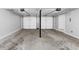 Spacious garage with high ceilings, overhead lighting, and concrete flooring, ready for customization at 212 Lake Forest Dr, Acworth, GA 30102