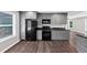 Kitchen features grey cabinets, black appliances, and marble countertops at 212 Lake Forest Dr, Acworth, GA 30102