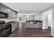 Open concept kitchen with stainless appliances, granite counters, and hardwood floors at 212 Lake Forest Dr, Acworth, GA 30102