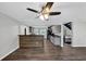 Open-concept living room with kitchen view, wood floors, and modern lighting at 212 Lake Forest Dr, Acworth, GA 30102