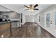 Open-concept living area with hardwood floors, ceiling fans, and a kitchen bar at 212 Lake Forest Dr, Acworth, GA 30102