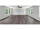 Bright living room boasts gray walls, dark-stained wood floors, and abundant natural light from large windows at 212 Lake Forest Dr, Acworth, GA 30102