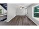 Bright living room with hardwood flooring, stairs, and natural light from large windows at 212 Lake Forest Dr, Acworth, GA 30102
