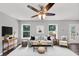 Cozy living room with neutral decor, modern furniture, and a ceiling fan at 212 Lake Forest Dr, Acworth, GA 30102