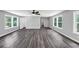 Large living room featuring a fan, many windows and beautiful wood floors at 212 Lake Forest Dr, Acworth, GA 30102