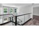 Modern staircase with sleek black railings and glass panels, offering a bright and open feel at 212 Lake Forest Dr, Acworth, GA 30102