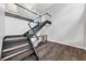 Modern floating staircase with glass railing and wood flooring in open living space at 212 Lake Forest Dr, Acworth, GA 30102