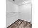 Empty walk-in closet with wood floors and shelf at 212 Lake Forest Dr, Acworth, GA 30102