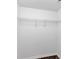 Walk-in closet with a single wire shelf and white walls above a modern laminate floor at 212 Lake Forest Dr, Acworth, GA 30102