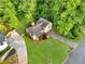 Aerial view of a home featuring a driveway, a well-manicured lawn, and verdant trees at 2929 Alberta Dr, Marietta, GA 30062