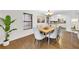 Bright dining room features hardwood floors, modern light fixture and is adjacent to the kitchen with all white appliances at 2929 Alberta Dr, Marietta, GA 30062