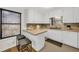 Bright kitchen with a breakfast bar offers neutral countertops and a window over the sink at 2929 Alberta Dr, Marietta, GA 30062