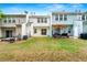 Expansive backyard view highlighting the patio, lawn, and well-maintained exteriors of the townhome at 4100 Howell Park Rd, Duluth, GA 30096