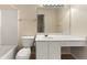 Bathroom featuring a single sink vanity, tub, toilet, and a large mirror at 4100 Howell Park Rd, Duluth, GA 30096