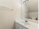 A functional bathroom features a vanity with a single sink, mirror, and modern lighting at 4100 Howell Park Rd, Duluth, GA 30096
