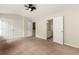 A large bedroom with carpet flooring features double closets and an open bathroom entrance at 4100 Howell Park Rd, Duluth, GA 30096