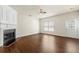 Cozy living room shows hardwood floors, a decorative fireplace, and plenty of natural light at 4100 Howell Park Rd, Duluth, GA 30096
