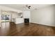 Spacious living room featuring hardwood floors, an open view to the kitchen, and a fireplace at 4100 Howell Park Rd, Duluth, GA 30096