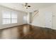 Bright living room boasts hardwood floors, a staircase, a ceiling fan, and access to the front entrance at 4100 Howell Park Rd, Duluth, GA 30096