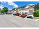A street view showcases townhomes, each with unique exterior colors and well-maintained landscaping at 4100 Howell Park Rd, Duluth, GA 30096