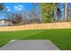 The huge fenced backyard features a lush lawn, patio, and mature trees, creating a private outdoor oasis at 4806 Forest Trl, Douglasville, GA 30135