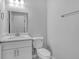 Bathroom featuring white sink, vanity, toilet, and neutral decor at 4806 Forest Trl, Douglasville, GA 30135