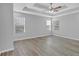Spacious bedroom with tray ceiling, ceiling fan, hardwood floors, and large windows for natural light at 4806 Forest Trl, Douglasville, GA 30135
