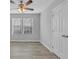 Bright bedroom featuring hardwood floors, modern ceiling fan, and window with blinds at 4806 Forest Trl, Douglasville, GA 30135