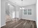 Dining room with hardwood floors, large windows, a chandelier, and a staircase nearby at 4806 Forest Trl, Douglasville, GA 30135