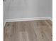 This empty room has stunning light-colored wood floors and light grey walls with white trim at 4806 Forest Trl, Douglasville, GA 30135