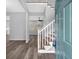 Open-concept entryway with staircase and gray walls, leading to living area with hardwood floors at 4806 Forest Trl, Douglasville, GA 30135
