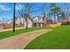 Exterior of a home with a curved driveway, expansive green lawn and wood privacy fence at 4806 Forest Trl, Douglasville, GA 30135