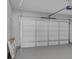 This large two car garage has new epoxy flooring, white walls, and a modern garage door opener at 4806 Forest Trl, Douglasville, GA 30135