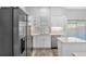 Kitchen features white cabinets, stainless steel appliances, and a tile backsplash at 4806 Forest Trl, Douglasville, GA 30135