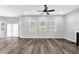 Spacious living room with hardwood floors, a ceiling fan, and large windows for ample natural light at 4806 Forest Trl, Douglasville, GA 30135