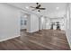 Open living area with hardwood floors, leading to a modern kitchen with white cabinets and an island at 4806 Forest Trl, Douglasville, GA 30135