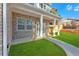 View of a covered porch with brick columns and well-maintained grass at 4806 Forest Trl, Douglasville, GA 30135
