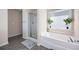 Bright bathroom featuring a separate tub and shower, and tile floors at 935 Mill Creek Ave, Canton, GA 30115