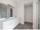 Bright bathroom featuring dual sinks, vanity and a separate glass door shower at 935 Mill Creek Ave, Canton, GA 30115