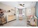 Cozy Bedroom featuring a crib, dresser, rocking chair, and soft décor, creating a peaceful environment at 935 Mill Creek Ave, Canton, GA 30115