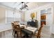 Elegant dining room with modern lighting, wainscoting, and a view into the kitchen at 935 Mill Creek Ave, Canton, GA 30115