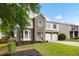 Charming two-story home with stone and siding exterior, well-manicured lawn, and attached garage at 935 Mill Creek Ave, Canton, GA 30115