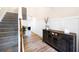 Open foyer with wood floors, wall paneling, and a view of the staircase and front entry at 935 Mill Creek Ave, Canton, GA 30115