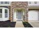 Inviting front entrance with stone accents, a welcome mat, and a well-manicured lawn at 935 Mill Creek Ave, Canton, GA 30115
