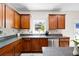 Kitchen featuring stainless steel appliances, wood cabinets, granite countertops, and backyard views at 935 Mill Creek Ave, Canton, GA 30115