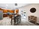 Bright kitchen features stainless appliances, wood cabinets, island, and adjacent dining area with backyard access at 935 Mill Creek Ave, Canton, GA 30115