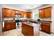 Kitchen with stainless appliances, granite counters, wood cabinets, and kitchen island at 935 Mill Creek Ave, Canton, GA 30115