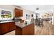 Open kitchen features stainless appliances, granite counters, wood cabinets, island, and backyard access at 935 Mill Creek Ave, Canton, GA 30115
