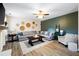 Comfortable living room showcasing a large sectional sofa, a ceiling fan, and unique decorative wall art at 935 Mill Creek Ave, Canton, GA 30115