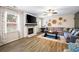 Living room features fireplace, modern decor, large sectional sofa, decorative wall art and lots of light at 935 Mill Creek Ave, Canton, GA 30115